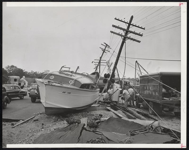 Boat on Land-This is one of many familiar sights on Cape Cod in the wake of Tuesday's storm. The power boat is sitting high and dry on a Wareham road where it was swept by wind and tide.