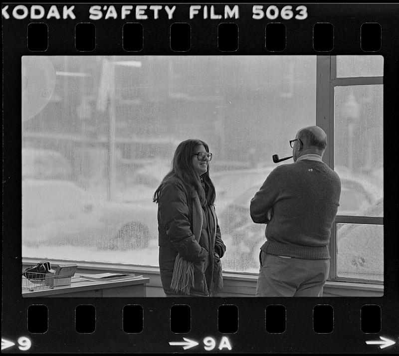 Two people in conversation during snow storm