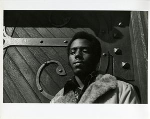 Teenage boy posing in front of ornate door