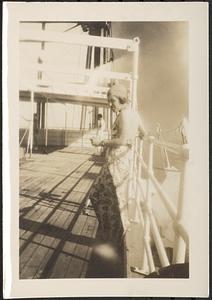 Woman standing on ship deck