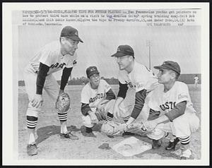 Pro Tips for Future Players - Two Venezuelan youths get pointers on how to protect third base while on a visit to the Houston Colts' spring training camp. Colt Bob Lillis (L) and Colt Eddie Kasko (RC) give the tips to Freddy Navarro, 15, and Ender Cobo,14, (R) both of Maracaibo, Venezuela.