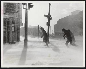 Man Against The Elements ended in a draw yesterday at Kneeland and Washington streets in Boston where three travelers leaned into the Arctic gale and battled their way to shelter from the bitter cold and snow.