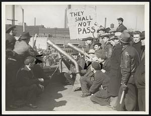 Sit-down strikers gathered around the crudely constructed cannon and held the fort on the roof of the Dodge plant Wednesday as more than 20,000 union sympathizers held a demonstration in the street. The strikers defied a court injunction ordering them to evacuate.