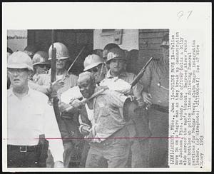 Jackson, Miss. – Police Move In – Police move in on a Negro man as they break up demonstration in Jackson, Miss. today. One officer holds a billy club across the man’s throat. Negroes threw rocks and bottles at police lines following funeral services for Medgar Evers, slain negro integration leader.