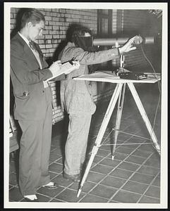 Measuring Light. Top of Court House. James E. Georgalos (Laboratory Engineer). Charles P. Woras (student Engineer)