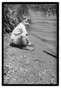 Boy by a body of water