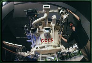 Boston: 1990 A display technician assembles part of a Soviet lunar rover, Museum of Science