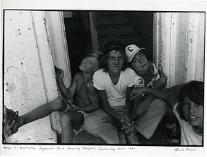 Four children sitting in a doorway.