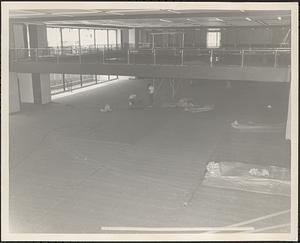 Construction of Boylston Building, Boston Public Library, laying carpet viewed from Mezzanine