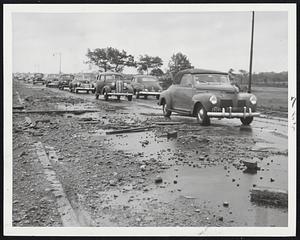 In Wake Of High Tide - Planks, stone and gravel litter Quincy Shore drive near Wollaston Beach after a night of gales and high water that swept across the roadway.