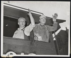 All's Right Now and the "Paul revere" to Chicago rides again from South Station. Bidding goodbye, although not a very happy one, are Ralph M. Burch (left). fireman, and Charles O. Carlson, engineer.