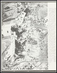 Looking like a collapsed doll house, the Veterans Administration hospital sows the effects of the rumbling earthquake that struck the Southern California area early 2/9, striking hardest in the northern San Fernando Valley area. Several deaths were reported as the three story building at the hospital collapsed, burying patients and hospital workers alike. Rescue workers worked feverishly throughout the day looking for casualties.