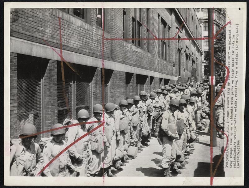 Army Troops Line Up for Strike Duty - Army troops line up on a sidewalk with packs on their backs for duty in Philadelphia's transportation crisis, resulting from a strike.