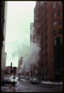 Steam coming from a pipe on a city street