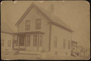 Mrs. Grainger in front of her new house