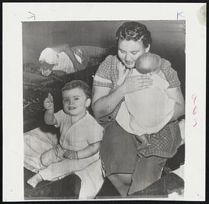 Refugees from Hurricane Ione in Wilmington, N.C., are Mrs. James F. Lucas Jr., who holds her two children Buddy, two months, and Barry, 15 months. They are in a hurricane shelter.