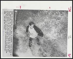 Swamped--Donald Gumble of St. Augustine, Fla. gets a thorough dousing as a giant wave smashed against the sea wall tonight. Winds and tides were growing because of Hurricane Dora which is slated to strike the Florida coast Wednesday.