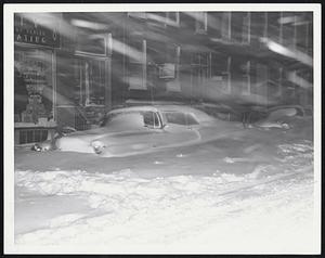 Locked In Tight in this car on Charles street as high winds pile snow higher and higher around it. Many motorists were unable to shovel out and left cars in the drifts. Smart drivers remained at home and let storm howl.