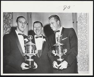Burdette and Spahn Get Awards--Pitchers, Warren Spahn (left) and Lew Burdette (right) pose with Braves General Mgr., John Quinn after they received trophies at the Milwaukee Baseball Writers fifth annual diamond dinner tonight. Spahn who signed his 1958 contract for about $65,000 dollars this afternoon, received his award for his pitching achievements in 1957 when he won 21 games and Burdette received his as the result of being the outstanding player in the World Series.