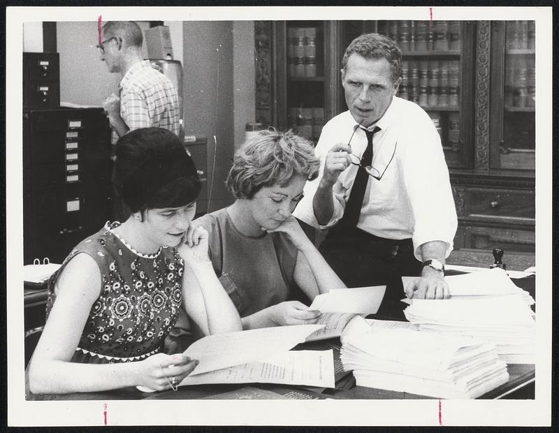 Engrossed - The final stage of bill which has been passed into law is the art of engrossing. Here, Secretary of State Kevin White discusses that with Anne Danehy, left, and Ann McDonough, on busy Friday.