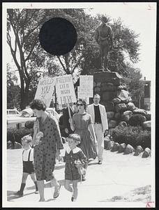 Pickets parade on Lexington Green behind famed Minuteman statue in protest against alleged housing discrimination involving James A. Parker (inset).