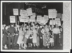 Pier Pickets--Placard-carrying pickets who identified themselves as "American-Irish Minutemen" picket near Pier 90 here last night as the liner Mauretania docked carrying British Foreign Secretary Ernest Bevin and Chancellor of the Exchequer Sir Stafford Cripps. The British officials are here for three-power talks on Britain's economic plight.
