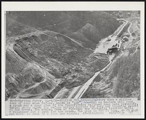 Million Ton Landslide-More than a million tons of coal mine refuse, known as "gob", blocked an Eastern Ohio road, a creek and a spur line of the Pennsylvania railroad near here yesterday. Aerial photo shows the refuse moving across the road and blocking waters of the creek. The mining town of Florence was virtually isolated until a bulldozer cut a path for the creek. The pile is 700 ft long, 40 ft high and moved at rate of a foot per minute.
