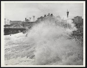 Fury of the hurricane rushing northward from Cape Hatteras is vividly seen in this photo. A seething wave froths white and high as it breaks near the boardwalk at Asbury Park, N. J.