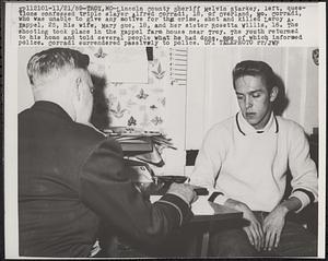 Lincoln County sheriff Melvin Starkey, left, questions confessed triple slayer Alfred Corradi, 18, of Overland, Mo.