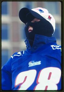 Boston City Hall Plaza (circa 1997) a New England Patriots fan wears a face mask from the cold weather