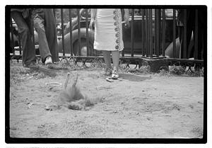 Two young women playing horseshoes