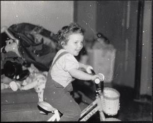 Child riding a bicycle with a basket
