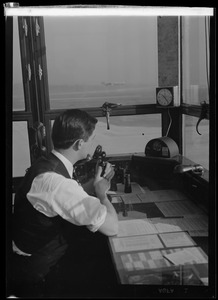 American Airlines traffic control tower. Man speaking into microphone