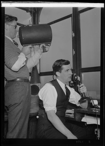 American Airlines traffic control tower. Man speaking into microphone and man pointing signal lamp