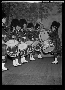 Drummers from the Scottish Highlanders Pipe Band playing instruments