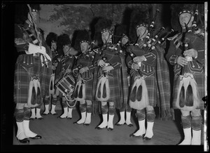 Musicians from the Scottish Highlanders Pipe Band playing drums and bagpipes