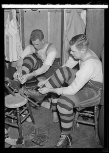 Boston Bruins Ray Getliffe and Frederick "Bun" Cook lace up their skates