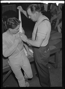 Boston Bruins trainer Win Green wraps the shoulder of Jim "Peggy" O'Neill