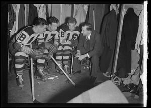 Boston Bruins manager/executive Art Ross addresses three players