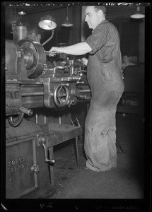Man operating a machine in maintenance garage