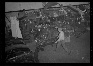 Man pushing a hand truck through garage