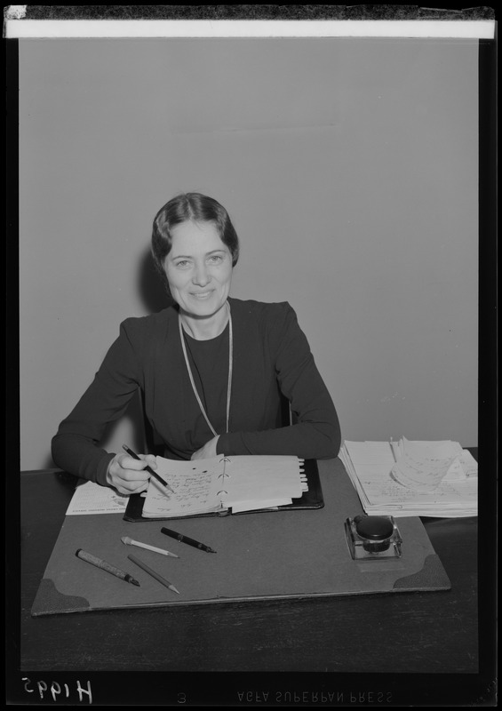 Portrait of Mrs. Higgs seated at desk