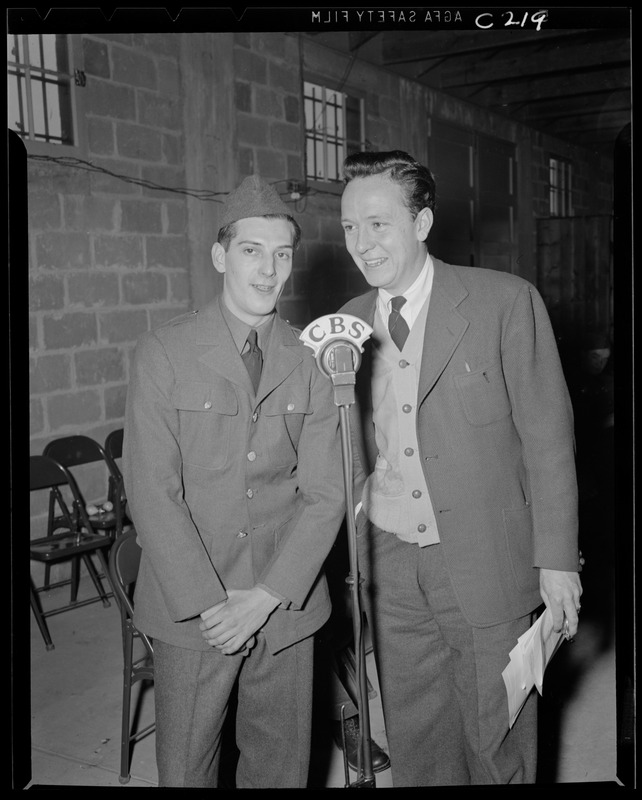 Two men in front of CBS microphone