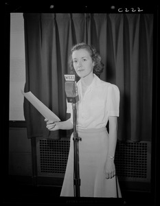 Portrait of a woman sitting at WEEI microphone