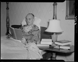 Cedric Foster reading in bed