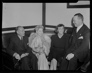 Mrs. Warren, seated with group on couch