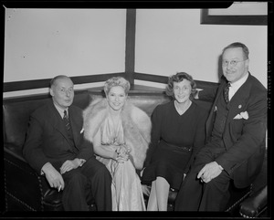 Mrs. Warren, seated with group on couch