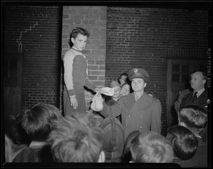 Victory volunteer passes a bag of pennies