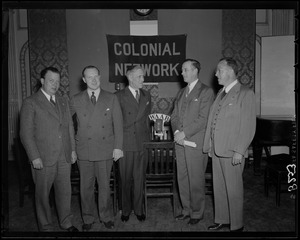 Broadcasters in front of Colonial Network Sign