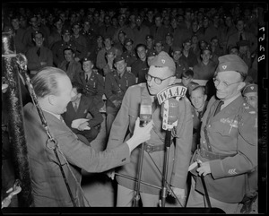 Two servicemen being interviewed at boxing match